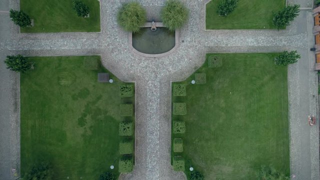 Aerial top down view of symmetrical campus park with fountain. Drone shot flying over urban garden in KTH Royal Institute of Technology university in Stockholm, Sweden