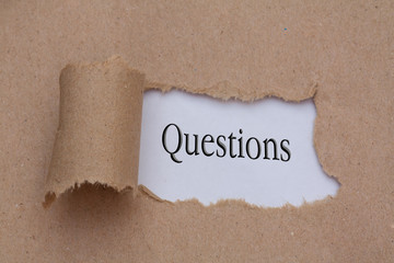 Torn paper with word questions