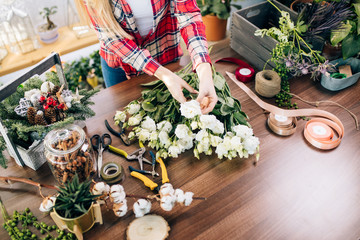 Small business owner and beautiful florist woman preparing a white flower bouquet, enjoy working with plants and flowers. Botany, plants concept