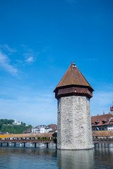 Famous stone tower at Chapel bridge on blue sky for backgrond with copy space, Luzern, Switzerland