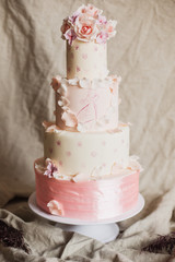 An example of three beautiful wedding cakes from a pastry chef. Elegant and unusual design with edible gold and sugar flowers.