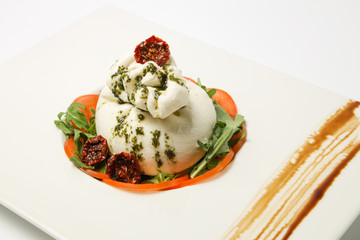 buratto cheese on a plate of vegetables