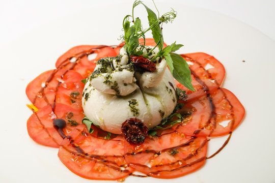 buratto cheese on a plate of vegetables