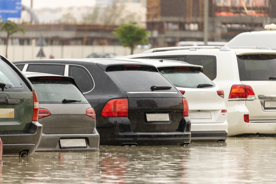 Cars stuck in water in a flooded parking lot after heavy in rain in Dubai