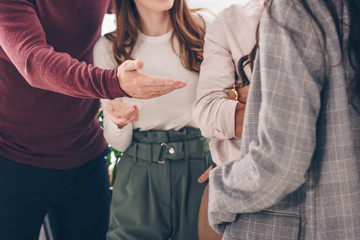 selective focus of coworkers posing while standing in office
