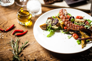 Fototapeta na wymiar Octopus salad served on a plate in restaurant