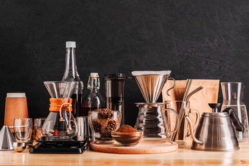 Accessories and utensils for making coffee drinks on a wooden table, coffee shop interior