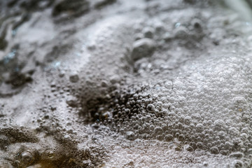 Boiling foam in a saucepan on an electric stove