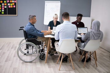 Disabled Businessman In Conference Room