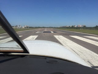 Aircraft aligns at runway head at Jacarépagua airport starting takeoff