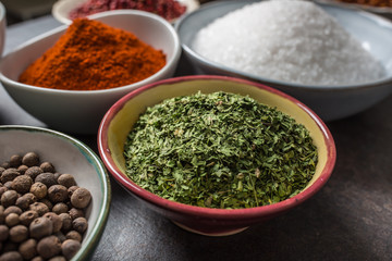 Dried parsley and variety spices and herbs in bowls