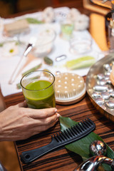 Hand taking a glass of healthy beverage