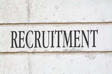Obraz premium Written RECRUITMENT word on concrete wall background