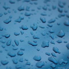 drops of water on blue metal