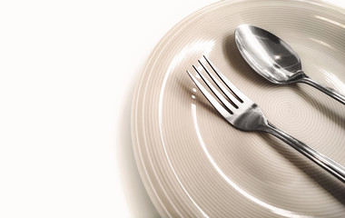 silver spoon and fork with plate