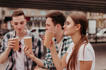 Three Friends Having Hot Drinks outdoors In Plastic Cups Outdoor.