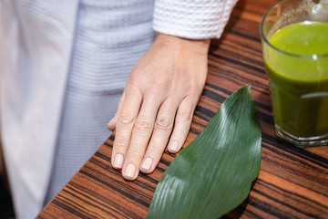 Woman standing near a glass of smoothie