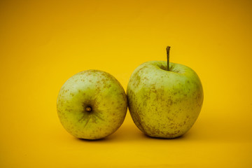 Bio green apples on a yellow background