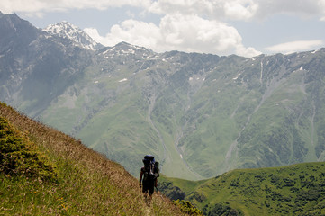 Fototapeta na wymiar Prepared tourist walking in the high mountains
