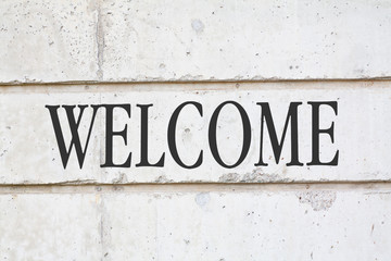 written WELCOME word on concrete wall background