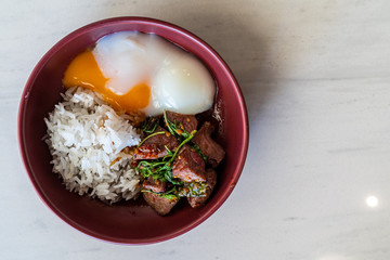 Stir-fried minced dried beef with spicy basil sauce and fried egg