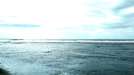 Fototapeta premium beautiful beach scenery, visible black coral in the middle of the sea