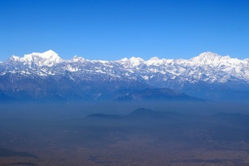 Scale of the Himalayas / Enormous of the Himalaya ranges above the cloud and layer of dust over Nepal