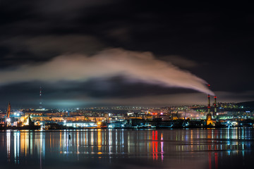 Fototapeta premium night Murmansk, city lights reflected in the Bay and the ships standing in the port