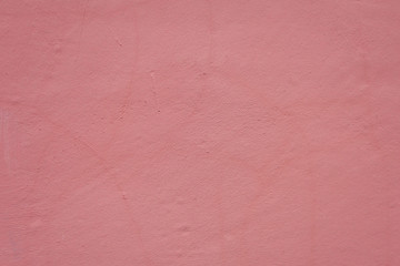 Background image - pink textured plaster wall of a building