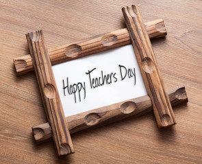 Text Happy Teachers Day written on wood frame