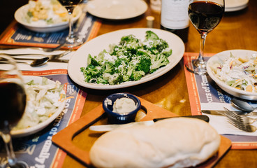 Food on a table with a glass of red wine, Italian cuisine, 
