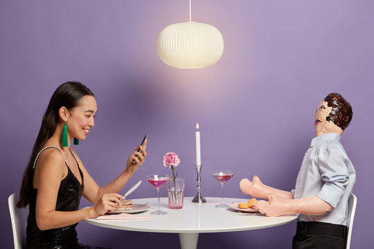 Positive lady checks email box on cellular, has online virtual love, finds boyfriend in social networks, prepares for first meeting in restaurant, talks to male mannequin, imagines this situation