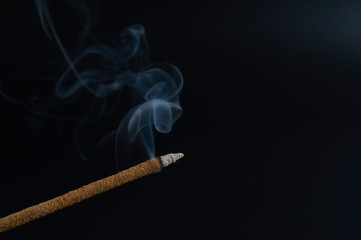 incense stick on a dark background close-up