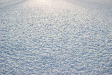 Snow illuminated by the slanting rays of the sun, photo taken at an angle