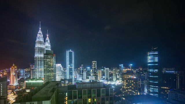 Kuala Lumpur, Malaysia - November 30, 2019: Time lapse of night scene at Kuala Lumpur Petronas Twin Towers KLCC and surrounding building. 