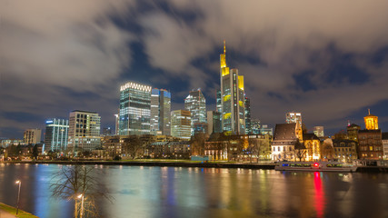 Naklejka na ściany i meble The Skyline of Frankfurt by night, seen from the river Main. 