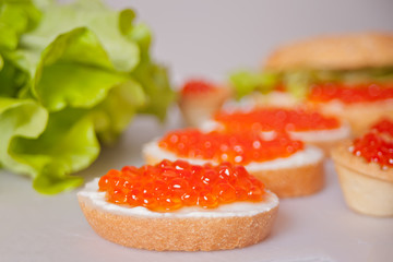 Fresh red caviar on bread. Sandwiches with red caviar.Delicatessen. Gourmet food