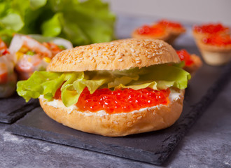 Fresh red caviar on bread. Sandwiches with red caviar and tartles with red caviar. Delicatessen. Gourmet food