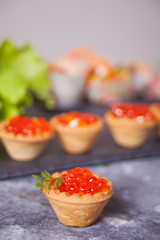 Fresh red caviar in tartlets. Delicatessen. Gourmet food