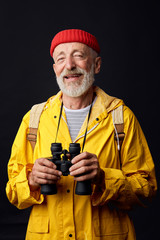 happy hiker man tourist looking at the camera. Hiking. Isolated over black background.close up photo. lifestyle, free time, spare time