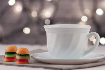 Cup of fresh aromatic coffee on a table with marmalade canapes