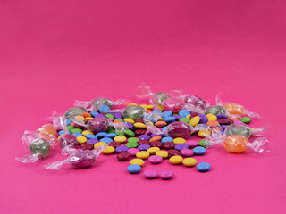 Colorful candies on a pink background stock images. Sweets on pink background. Candy on a pink background with copy space for text