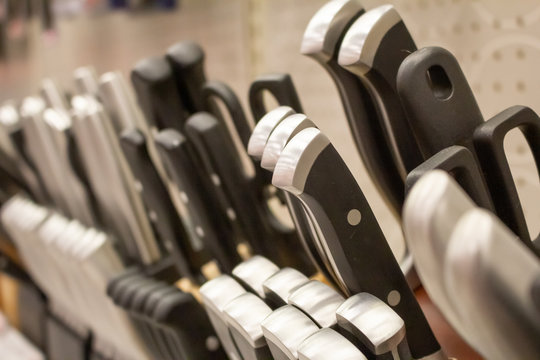 A view of several handles of knife block collections, on display at a local retail store.