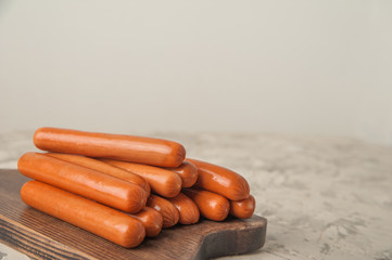 Close-up of sausages. Sausages on the blackboard and place for text. Boiled raw bavarian sausages and copy space.
