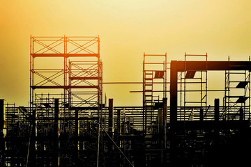 silhouette of a construction building with sunset sky