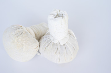 Two spa herbal compress balls on white background.Spa treatment equipment concept.