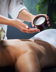 oil massage fragment of young beautiful woman in spa environment.  