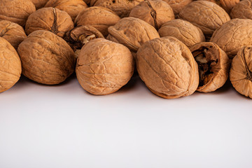 a large number of walnuts on a white background