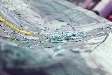 A closeup view of a broken and shattered car windshield.