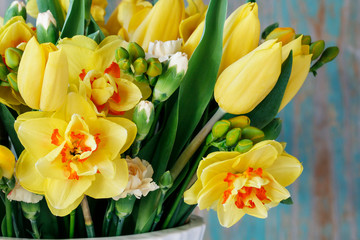 Obraz premium Spring bouquet with yellow tulips, carnations and daffodils